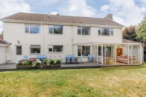 a house with a conservatory and a patio at Talbot House by Grandeur Property in Bournemouth