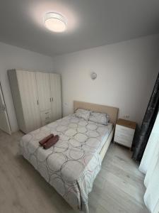 a bedroom with a bed in a white room at Apartament in Ploiești 7 in Ploieşti
