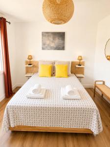 a bedroom with a bed with two towels on it at Maison moderne Parking &Jardin in Narbonne