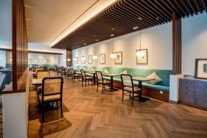 a dining room with tables and chairs at Rich Palace Hotel in Surabaya +22 photos