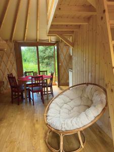 a room with a bed and a table and chairs at Jurajskie Jurty in Golczowice