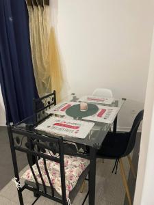 a glass table with a chair and a cup on it at Jana holiday in Paris in Arcueil