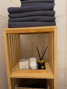 a shelf in a bathroom with a pile of towels at Penzion Tlustá kachna in Chrudim
