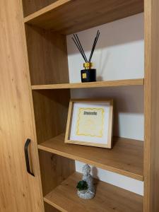 a wooden shelf with a framed picture in it at Penzion Tlustá kachna in Chrudim