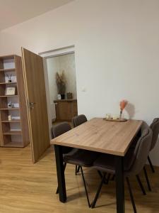 a dining room with a wooden table and chairs at Penzion Tlustá kachna in Chrudim +59 photos
