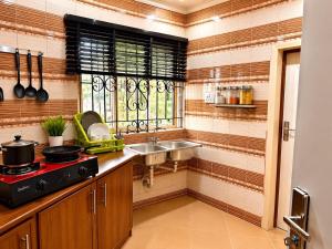 a small kitchen with a sink and a sink at Imtech Luxury Apartments in Uyo +13 photos