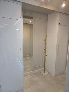 a room with white walls and a pole in it at GOLDEN HAUS Opole - Miss Gold & Mini Lux in Opole