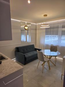 a living room with a couch and a glass table at GOLDEN HAUS Opole - Miss Gold & Mini Lux in Opole