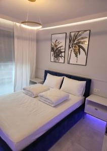 a bedroom with a large bed with two pillows at GOLDEN HAUS Opole - Miss Gold & Mini Lux in Opole +8 photos