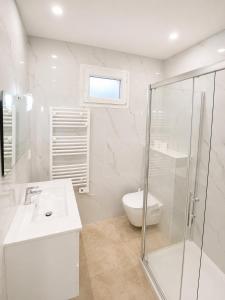 a white bathroom with a sink and a shower at Maison moderne Parking &Jardin in Narbonne +12 photos