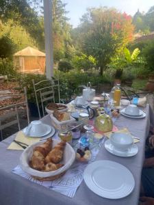 a table with a table cloth with food on it at Au Jardin in Moissac