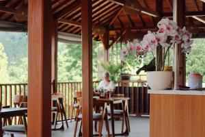 a person sitting at a table in a restaurant at STHANATAPA HILL's in Sidemen