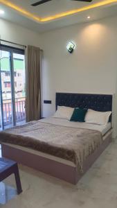 a large bed in a bedroom with a window at The Hilltop inn in Kelghar