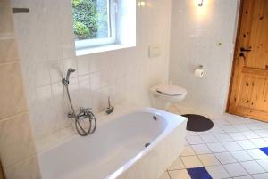 a white bathroom with a tub and a toilet at Zaumseil, Axel Fe-App "unten" in Schönberg