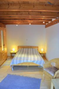 a large bed in a room with two tables at Zaumseil, Axel Fe-App "unten" in Schönberg +18 photos