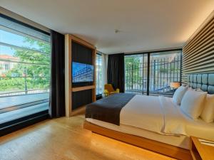 a bedroom with a large bed and large windows at Metropolitan Hotels Bosphorus - Special Category in Istanbul +252 photos