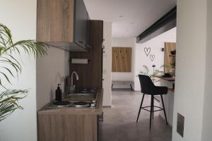 a kitchen with a sink and a chair in a room at Ferienwohnung Eifelmomente in Rittersdorf