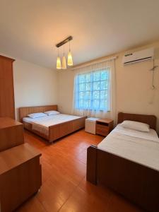 a bedroom with two beds and a window at Tinano in Kuchkisabano
