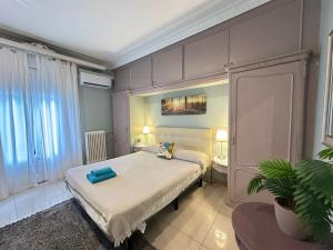 a bedroom with a large bed and a bathroom at Rooms Granvia in Barcelona