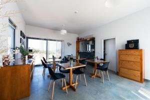 a dining room with tables and chairs in a room at Agroturismo Xistos in Cerca
