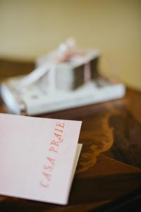 a piece of paper on a table with a phone at Casa Praie in Casasco