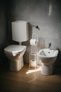 a bathroom with a toilet and a bidet at Casa Praie in Casasco +30 photos