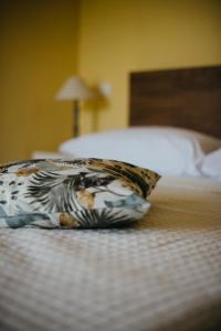 a pillow sitting on top of a bed at Casa Praie in Casasco