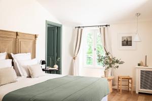 a bedroom with a large bed and a window at Domaine de Fontenille - Fontenille Collection in Lauris +93 photos