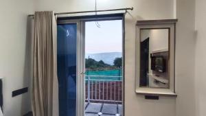 a bathroom with a mirror and a window with a view at The Hilltop inn in Kelghar