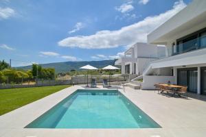 a swimming pool in the backyard of a house at Apex Premium Living in Leptokarya