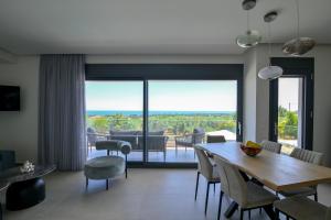 a dining room with a table and chairs and a view at Apex Premium Living in Leptokarya