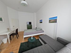 a living room with a couch and a bed at Zimmervermietung an der Bebra in Sondershausen