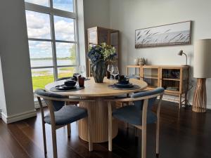 a dining room table with chairs and a vase of flowers at Tamula Panorama in Võru +5 photos