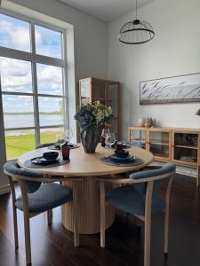 a dining room table with chairs and a vase of flowers at Tamula Panorama in Võru