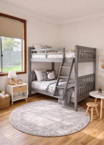a bedroom with two bunk beds and a rug at Barnard Beach House in Broadwater