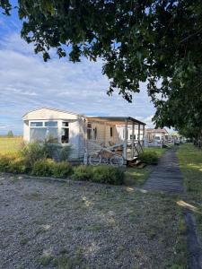 a house with a bike parked in front of it at Między polami in Drewnica