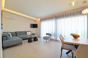 a living room with a couch and a table at Apex Premium Living in Leptokarya