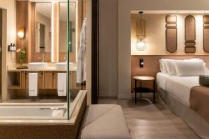 a hotel room with a bed and a bathroom at Barceló Tenerife Royal Level in San Miguel de Abona +69 photos