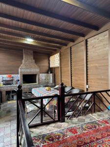 a living room with a table and a fireplace at Cottage on Issyk-Kul, Royal Beach in Chok-Tal