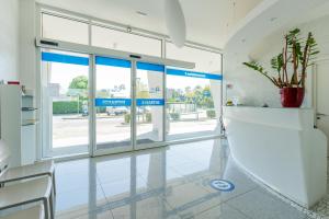 an empty lobby with glass doors and a potted plant at Residenza Turistica Alberghiera Blue Marine in Bibione +89 photos