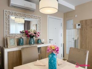 a dining room with a table with flowers in a blue vase at Sunwave in Cabanes +39 photos