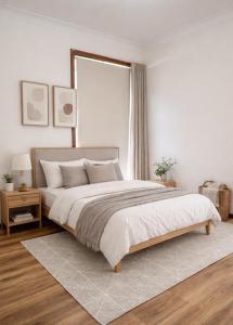 a bedroom with a large bed and a window at Barnard Beach House in Broadwater +3 photos