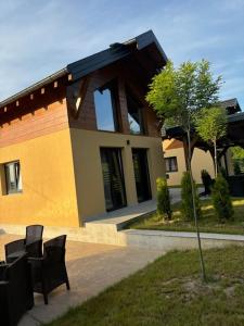 a house with two black benches in front of it at Zelena reka 3 in Simici