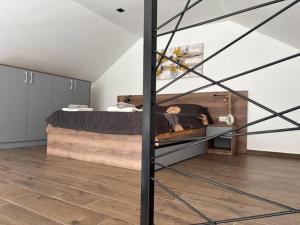 a bedroom with a bed and a staircase at Zelena reka 3 in Simici