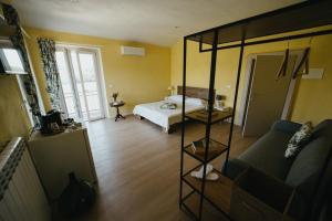 a room with a bed and a room with a couch at Casa Praie in Casasco
