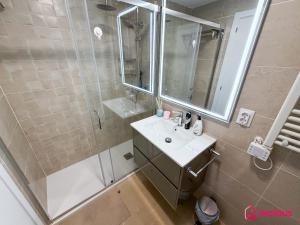 a bathroom with a shower and a sink and a mirror at Sunwave in Cabanes