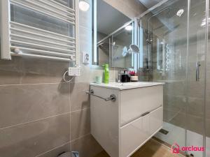 a bathroom with a white sink and a shower at Sunwave in Cabanes