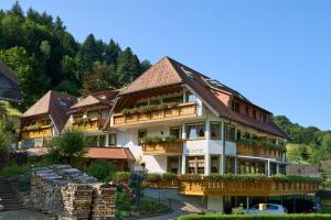 a large building with balconies and plants on it at Gasthaus Sonne in Münstertal