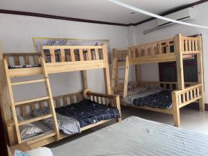 a room with three bunk beds in a room at FUBON World Guesthouse in Ban Nongpapao +3 photos