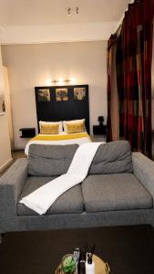 a bedroom with a large bed and a couch at Mapungubwe Hotel in Johannesburg